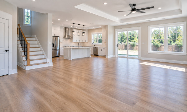Clean renovated property interior after construction cleanout with open floors, finished kitchen, and debris removed