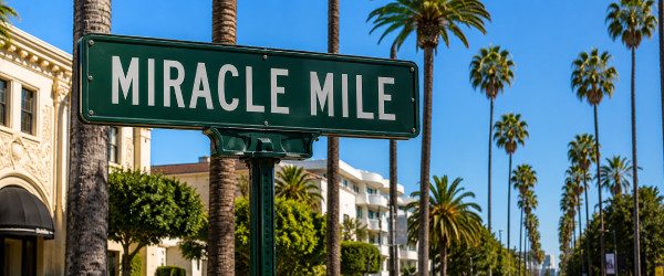 Miracle Mile service area sign with palm trees for Joober Junk Removal in Los Angeles.
